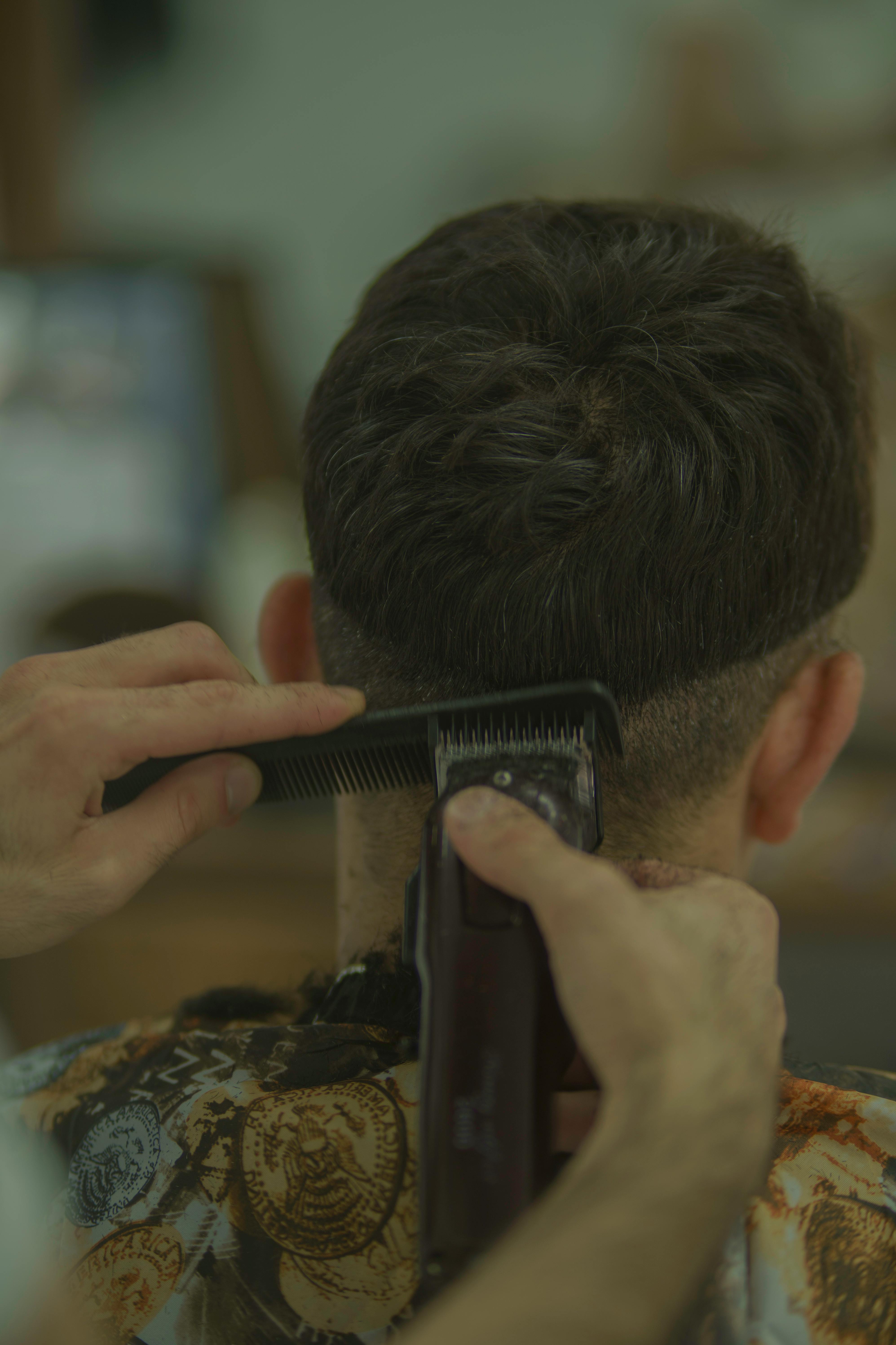 Close up of a Man Getting a Haircut at a Barbershop Free Stock Photo