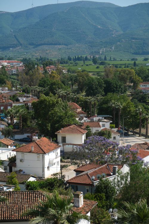 Free Aerial view of Selçuk, İzmir showcasing rooftops, greenery, and distant hills. Stock Photo