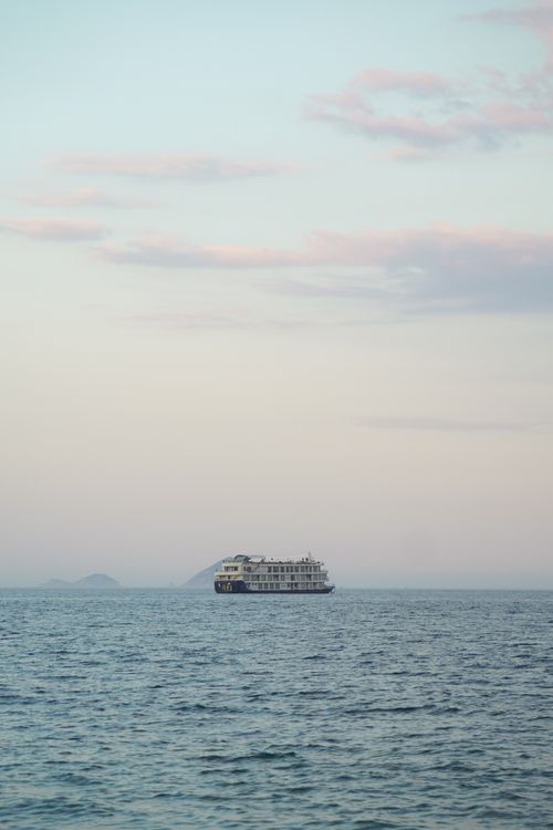 Free Peaceful scene of a ship on tranquil sea with a pastel sky in Nha Trang, Vietnam. Stock Photo
