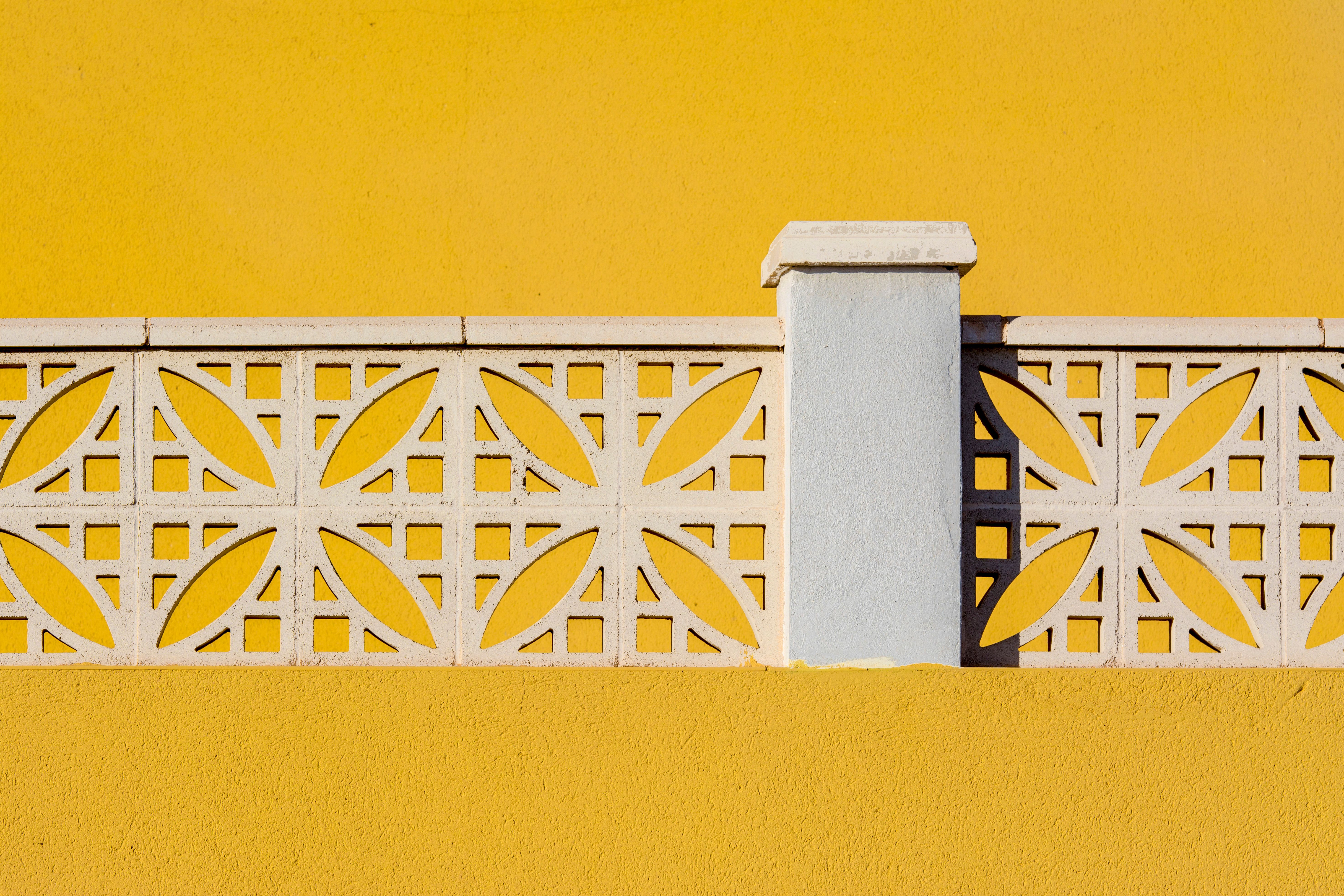 Close-up of White Details on a Yellow Wall · Free Stock Photo
