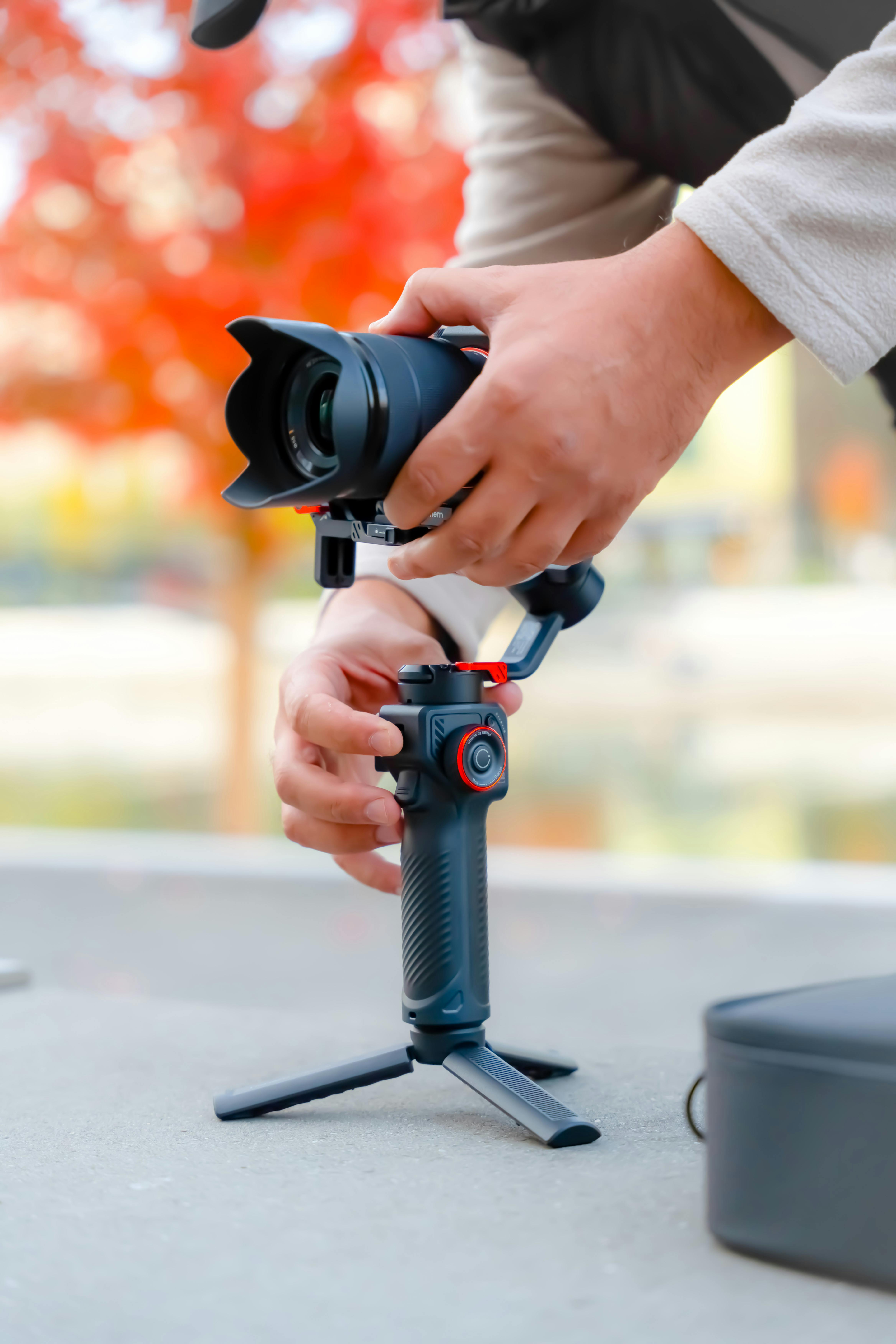 Hands Holding Tripod and Camera · Free Stock Photo