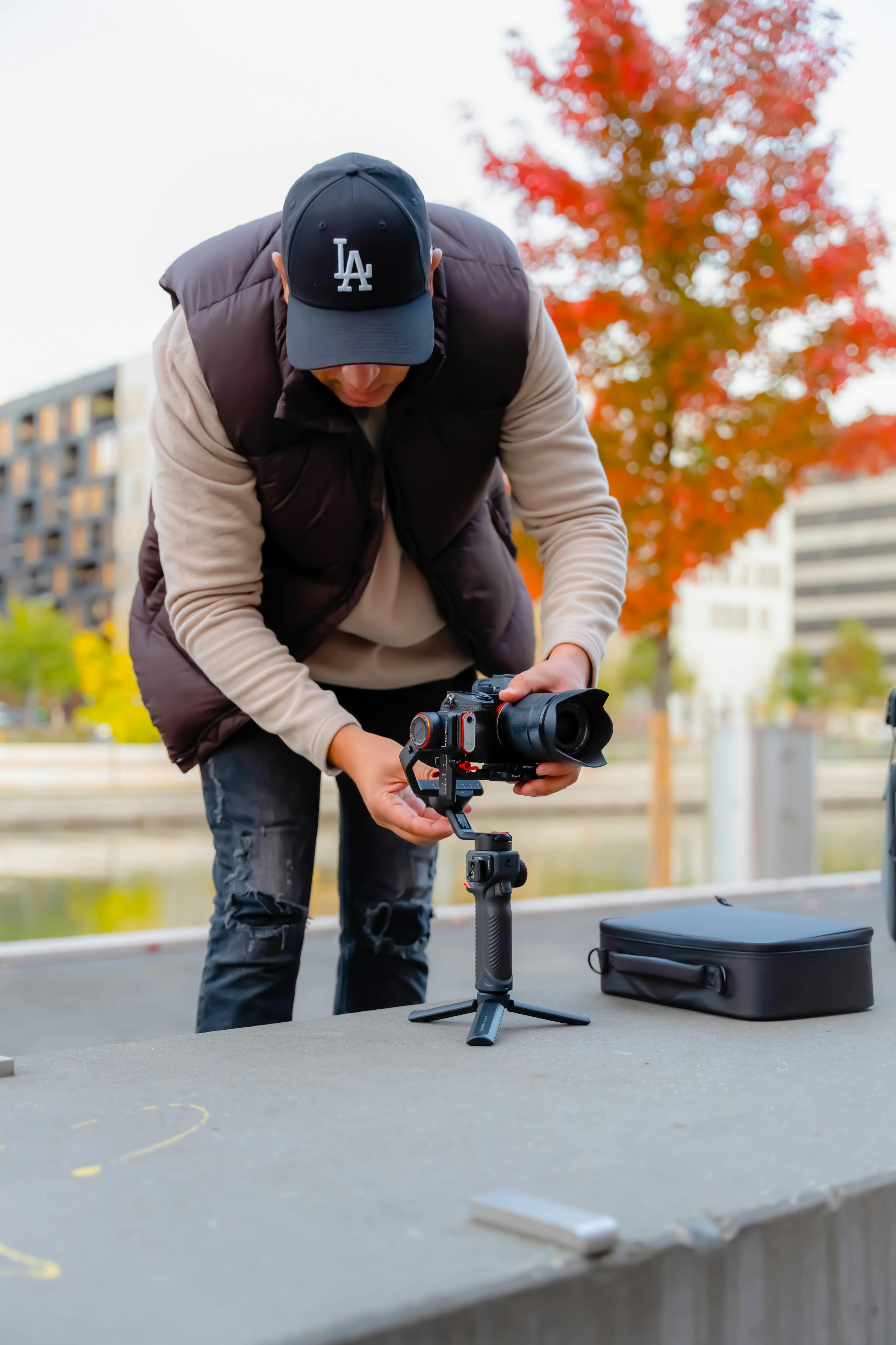 Man Preparing Camera for Recording Video · Free Stock Photo