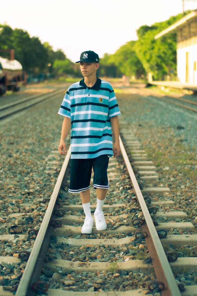 Young Man Walking On The Railway 