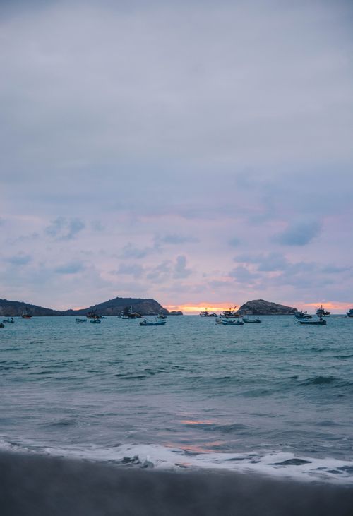 Free Scenic view of fishing boats during twilight at Machalilla, Ecuador. Perfect for travel and nature themes. Stock Photo