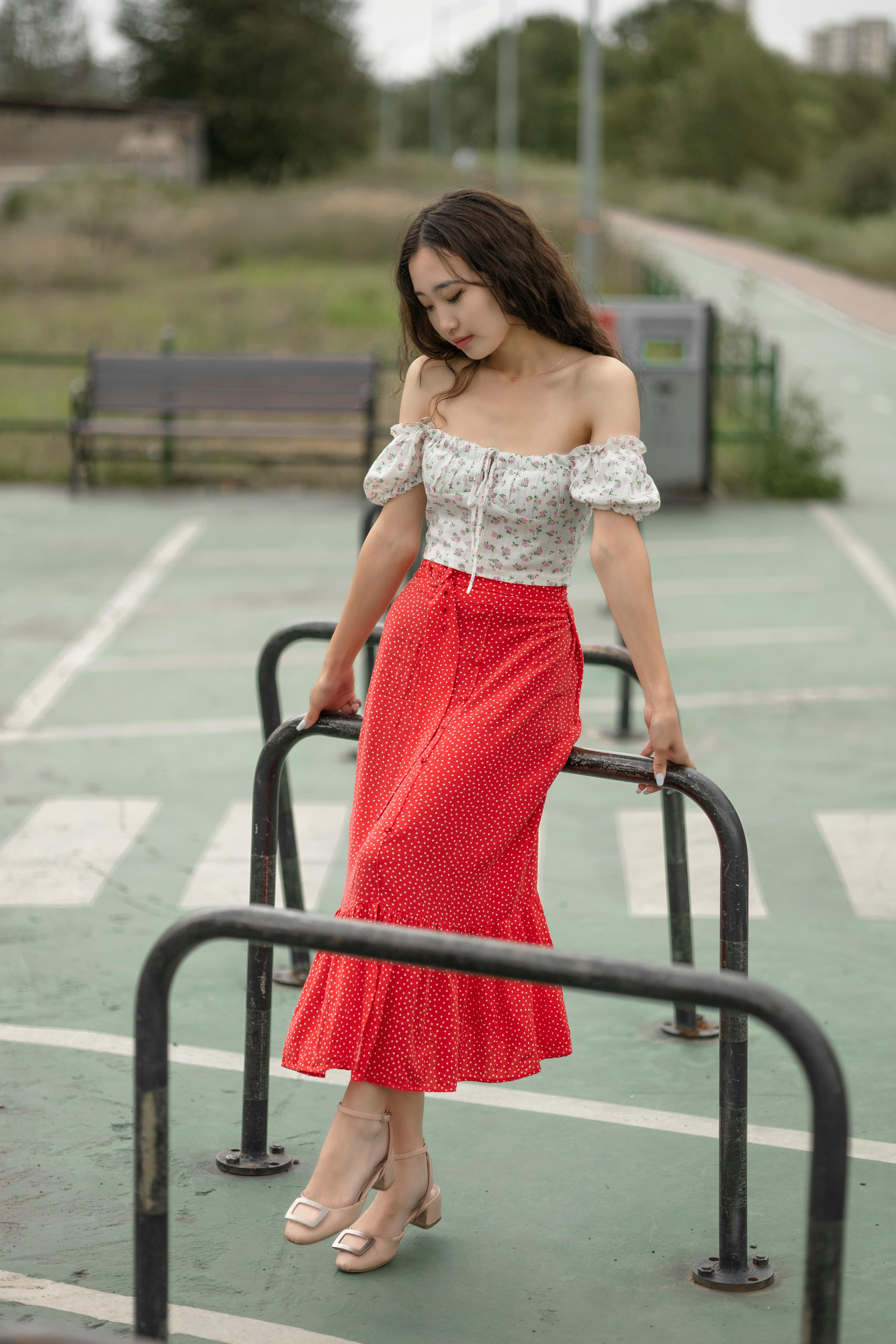 A woman in a red outfit posing for a picture photo – Free Fashion