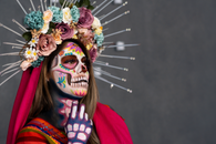 Colorful face paint and floral headdress celebrate Mexican Day of the Dead.
