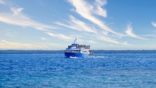 Free A vibrant ferry sailing on the open sea under a bright blue sky, capturing travel and adventure. Stock Photo