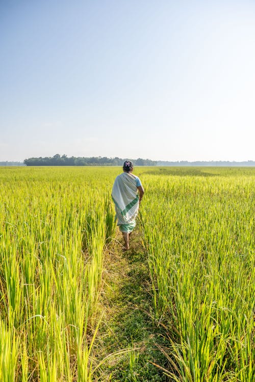 Woman Walking on Rural Field