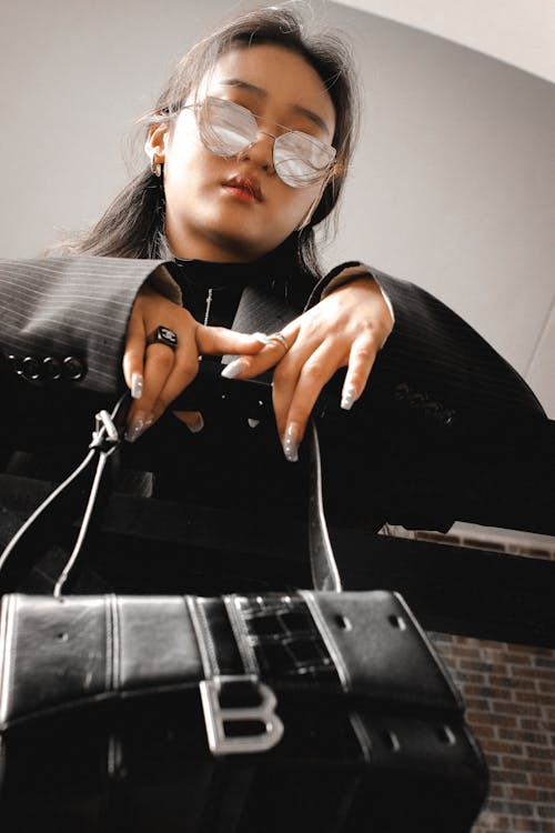 Close up of Woman with Black Bag and in Sunglasses