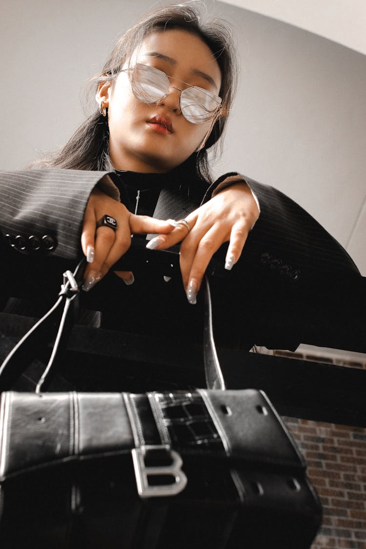 Close Up Of Woman With Black Bag And In Sunglasses