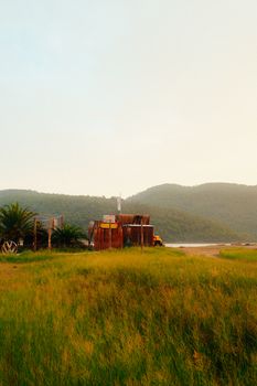 A rustic farmhouse nestled in a tranquil countryside setting with scenic mountains in the background.
