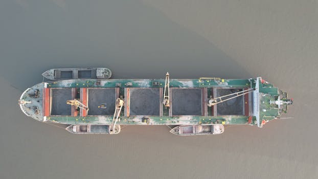Aerial view of a cargo ship navigating Harbaria, Khulna Division, Bangladesh.