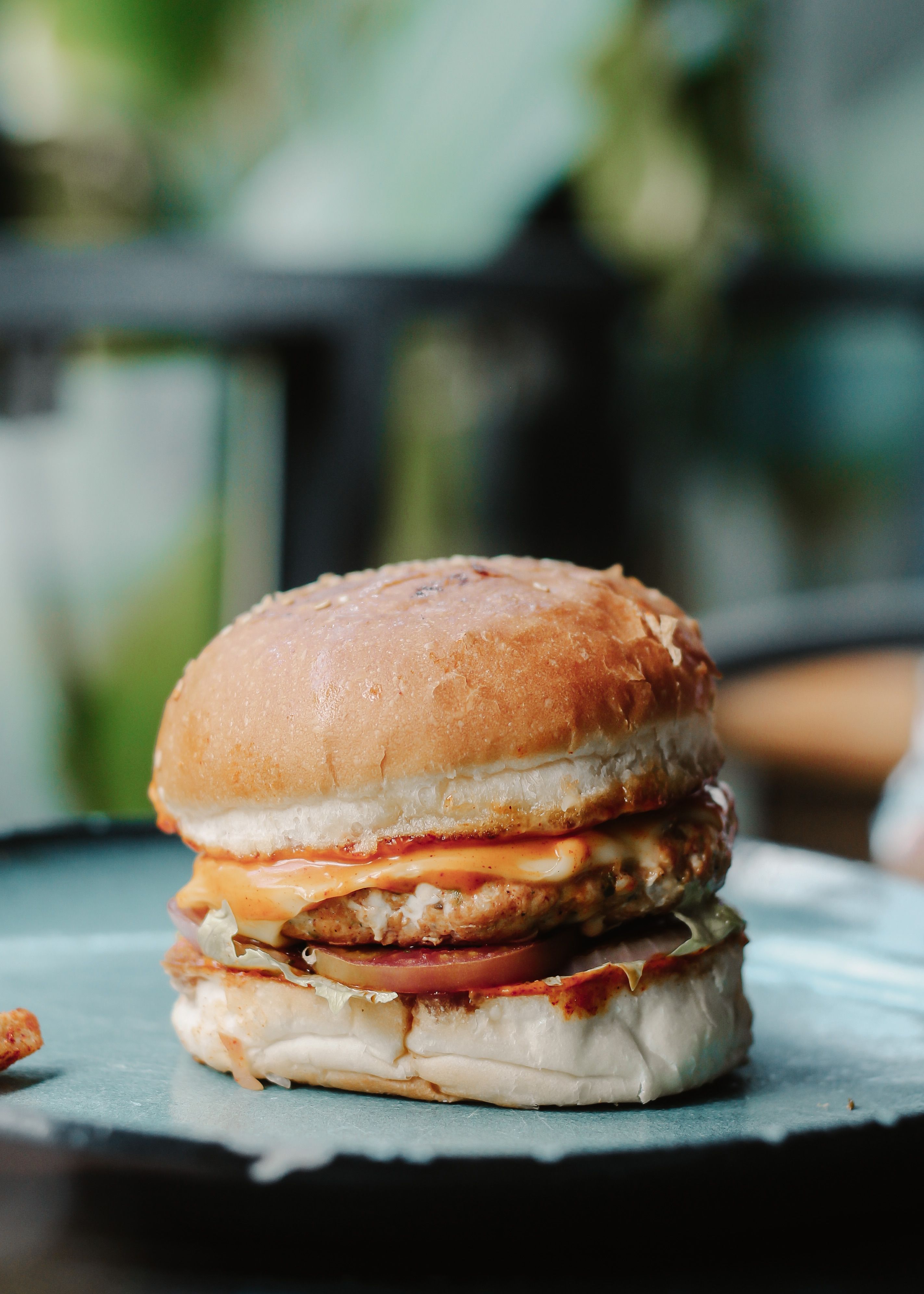 Delicious cheeseburger with bun and cheese served on a plate. Perfect for fast food themes.