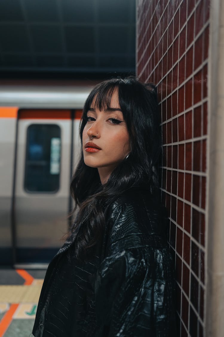 Brunette In Leather Jacket Posing At Subway Station