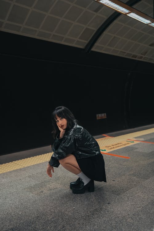 Model in Jacket and Mini Skirt Posing on Subway Platform