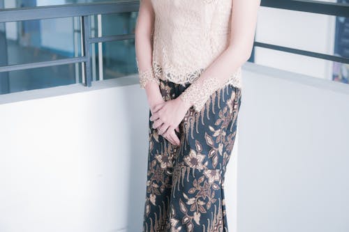 Model in White Blouse and Floral Pants