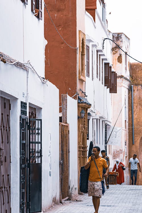 Walls of Buildings by Alley in Town