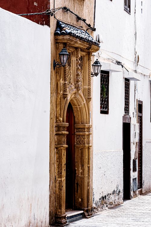 Free Vintage ornate entrance on a white urban wall with decorative lanterns. Stock Photo