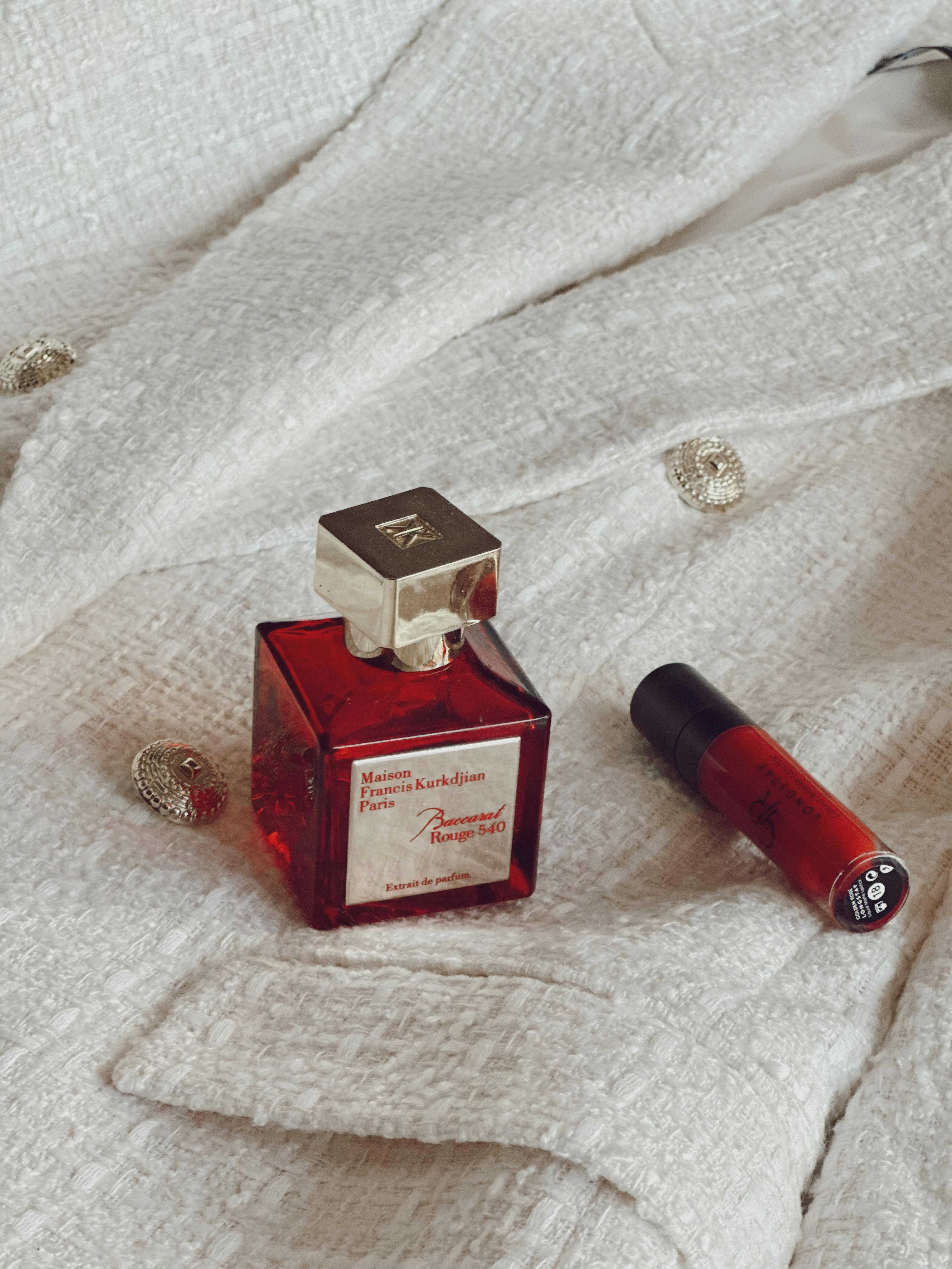 A vial and flask of luxury perfume