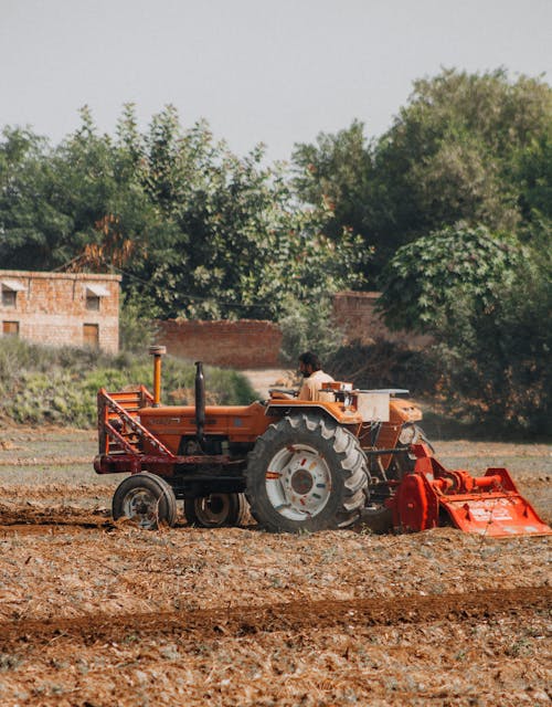 Farmer Working in Tractor on Field