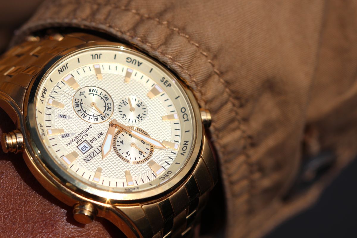 Person wearing a chronograph watch with subdials and a date display