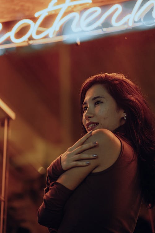 Young Woman in the Light of a Neon Sign