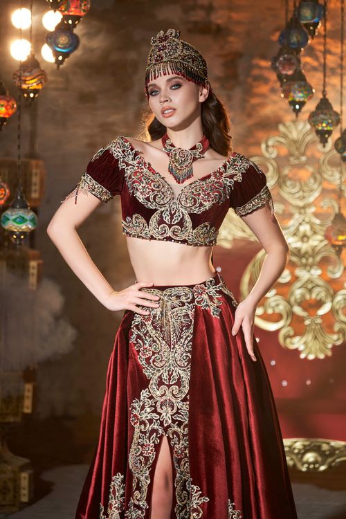 Free Stunning traditional Turkish dress with intricate embroidery, captured in a glamorous indoor setting. Stock Photo