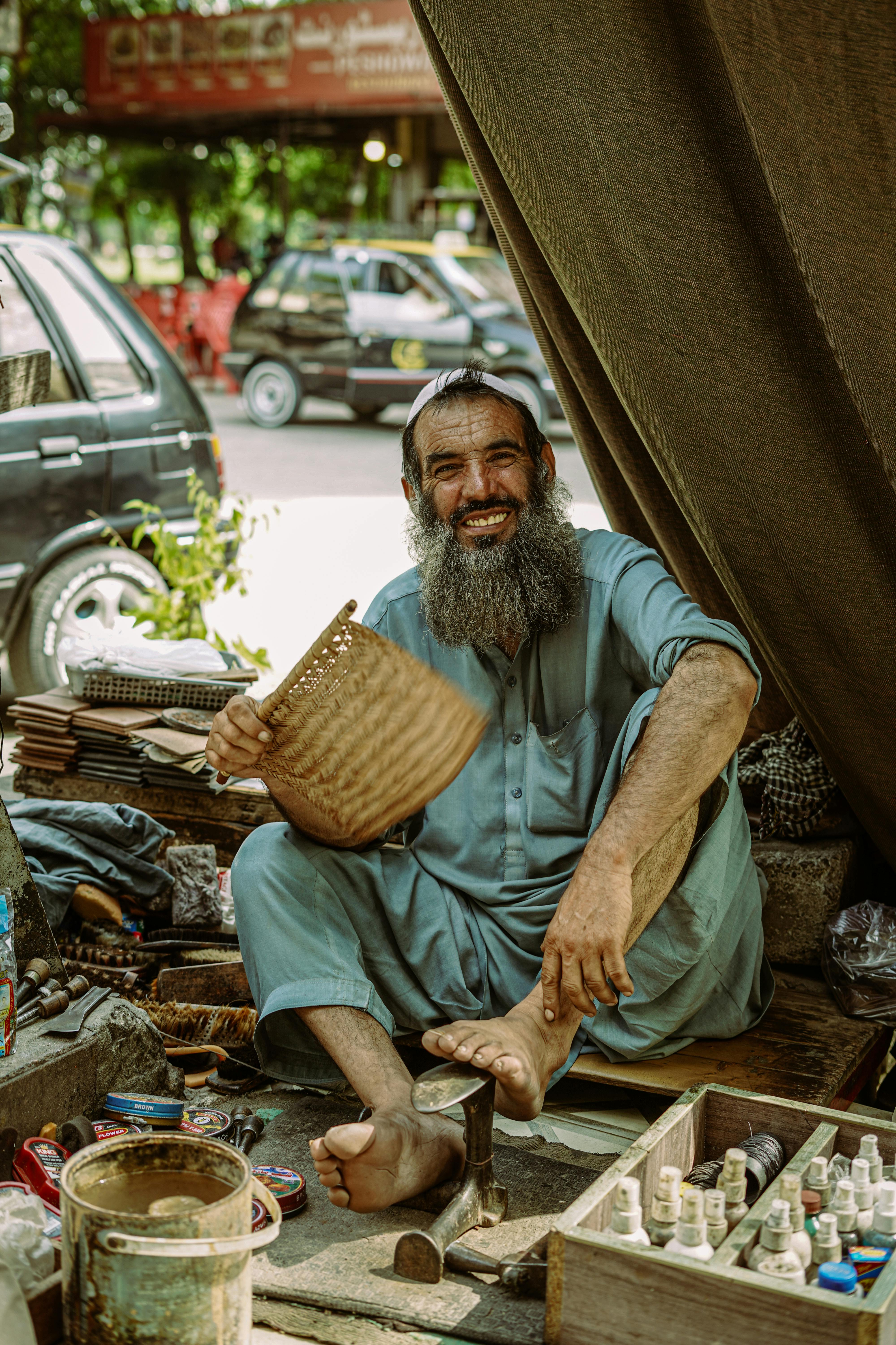 smiling elderly street vendor sitting