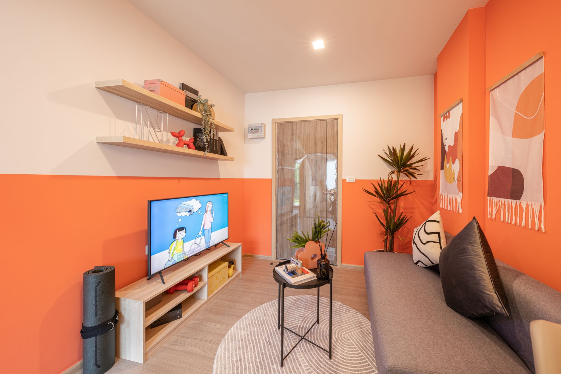 aesthetic apartment layout for beginners Contemporary living room featuring orange walls, stylish décor, and a cozy atmosphere.
