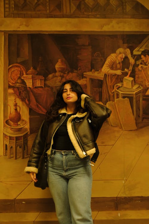 Young Brunette Woman in Leather Jacket and Jeans