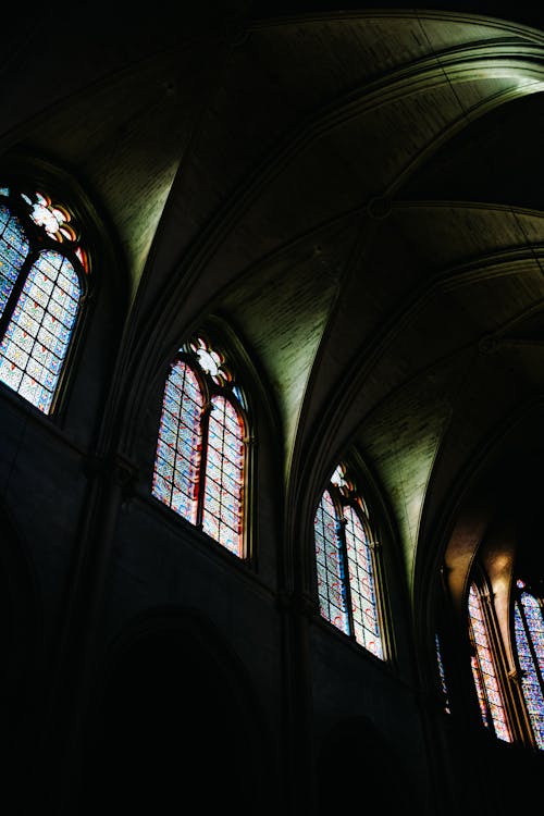 Wall in Darkness and Stained Glass Windows in Church