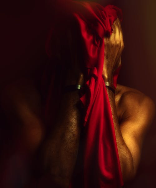 Man Holding a Red Scarf 