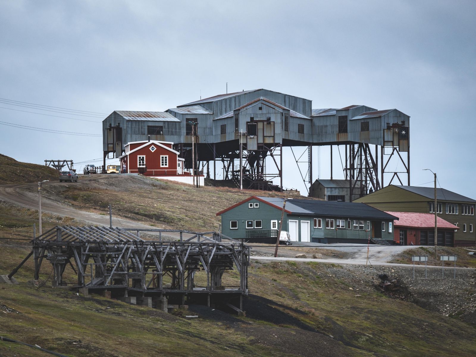 Weathered buildings of Longyearbyen, Svalbard, below bare Arctic hillsides.