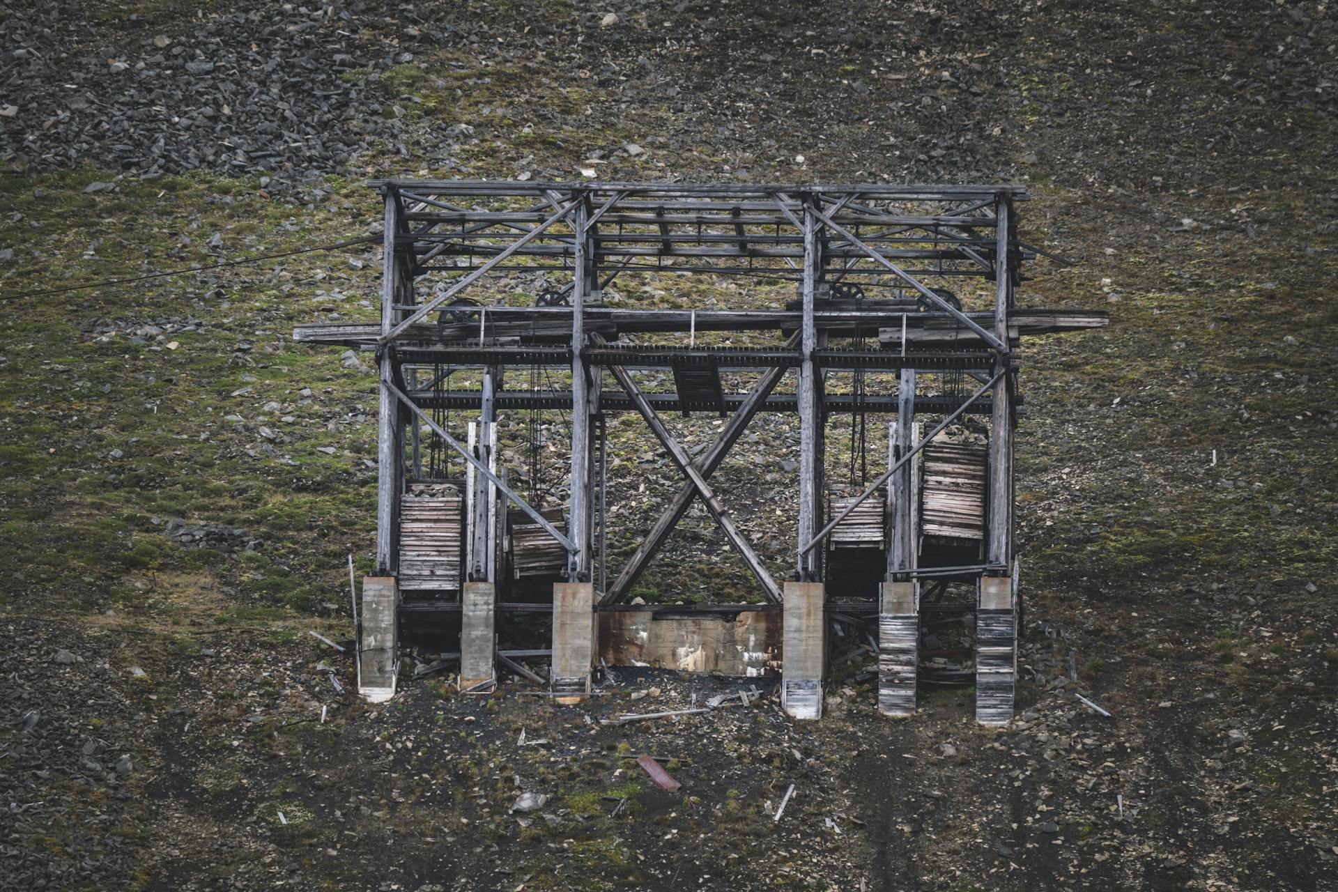 Aerial view of an abandoned wooden structure in a rural mining area.