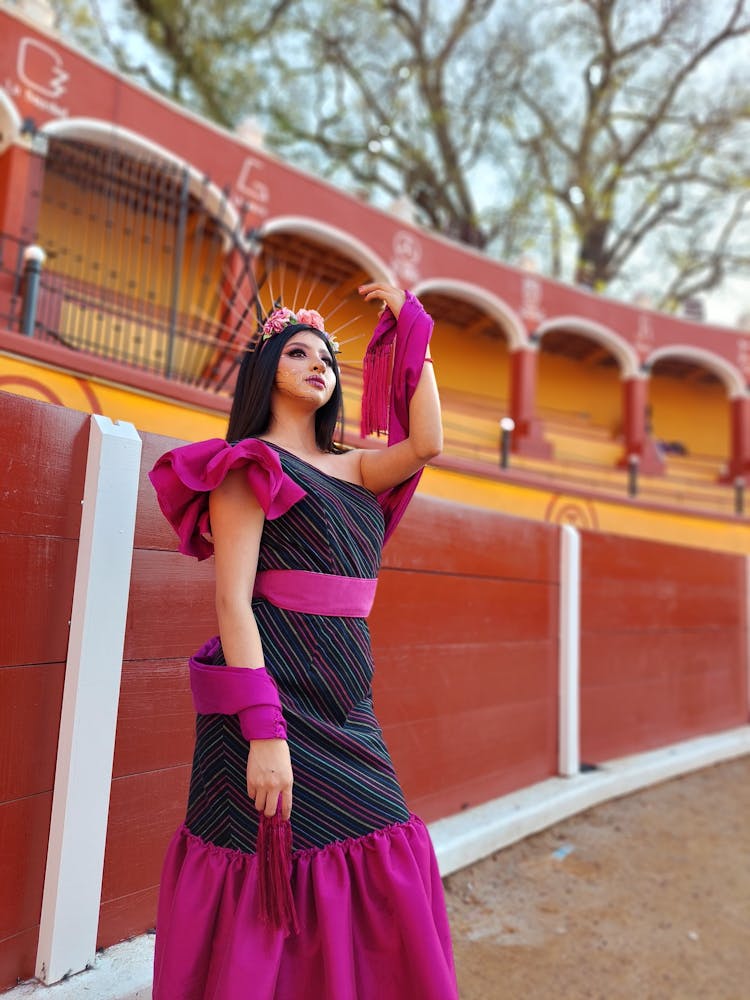 Woman Dressed As A Catrina Posing Outside 