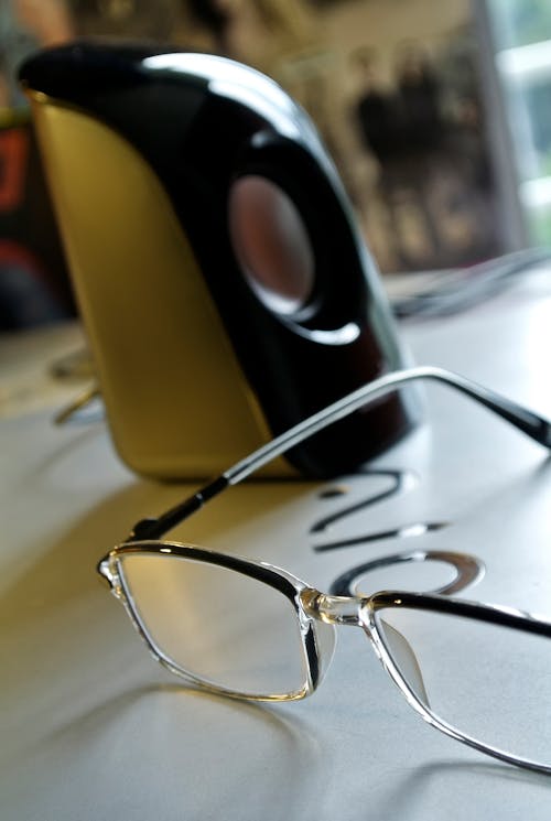 Free Black Frame Eyeglass Beside Black and White Electric Kettle Stock Photo
