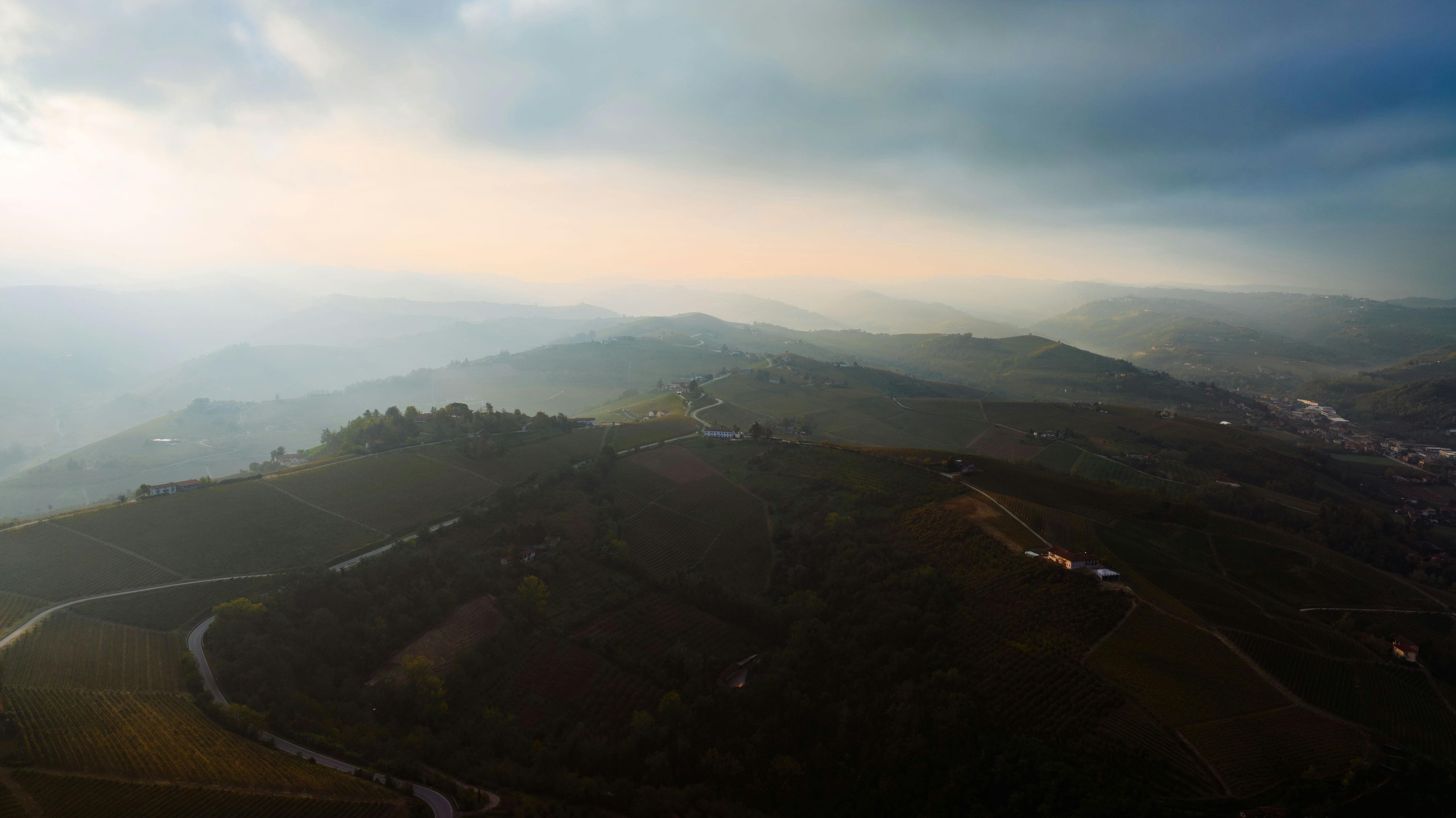 Stunning aerial panorama of the rolling hills in Piemonte, Italy captured during sunset.