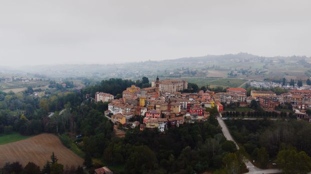 Scenic aerial view of Costigliole d'Asti village amidst lush countryside in Piemonte, Italy.