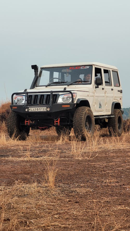 A Person Driving a Mahindra Bolero 4x4 SUV 