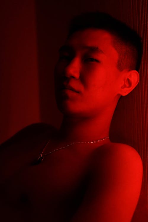 Photo of a Young Man in Red Lighting 