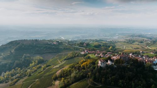 Free Breathtaking aerial shot of Novello village surrounded by lush vineyards and rolling hills in Piedmont, Italy. Stock Photo