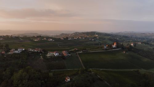 Free Breathtaking aerial view of Costigliole d'Asti's rolling hills and vineyards at dawn, showcasing a serene Italian countryside landscape. Stock Photo