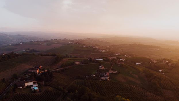 Scenic aerial view of Piemonte's rural landscape during sunrise.