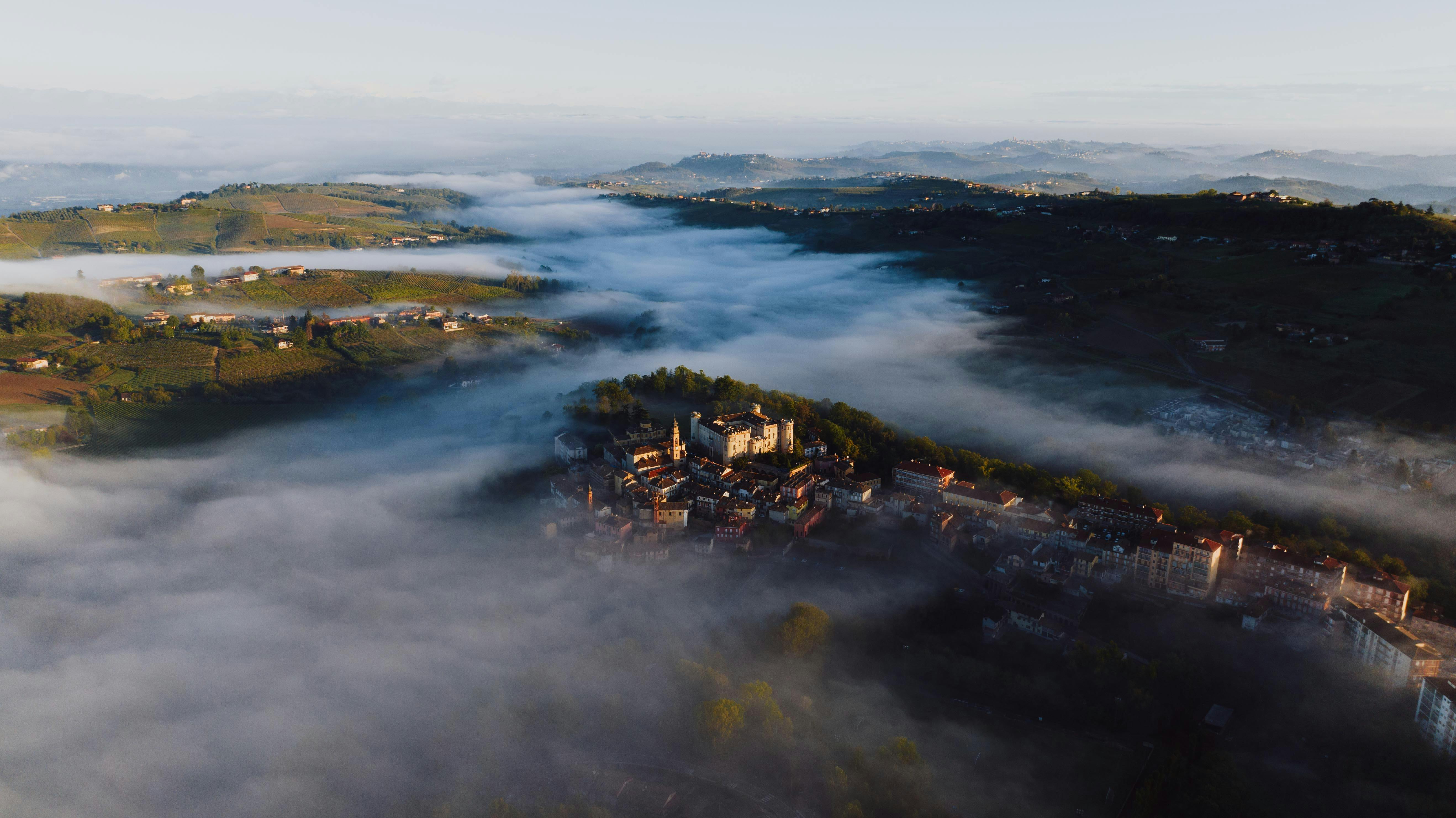 Aerial view of Ho town with green hills and mist in the background