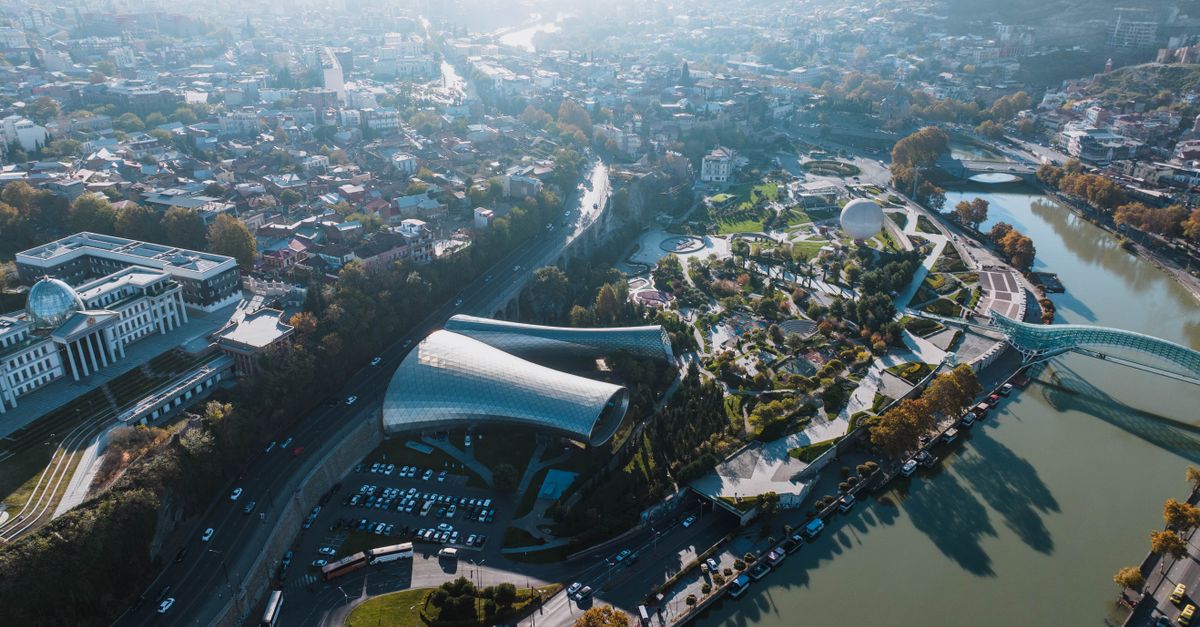Stunning aerial view of Tbilisi, Georgia, featuring modern architecture and lush landscapes.
