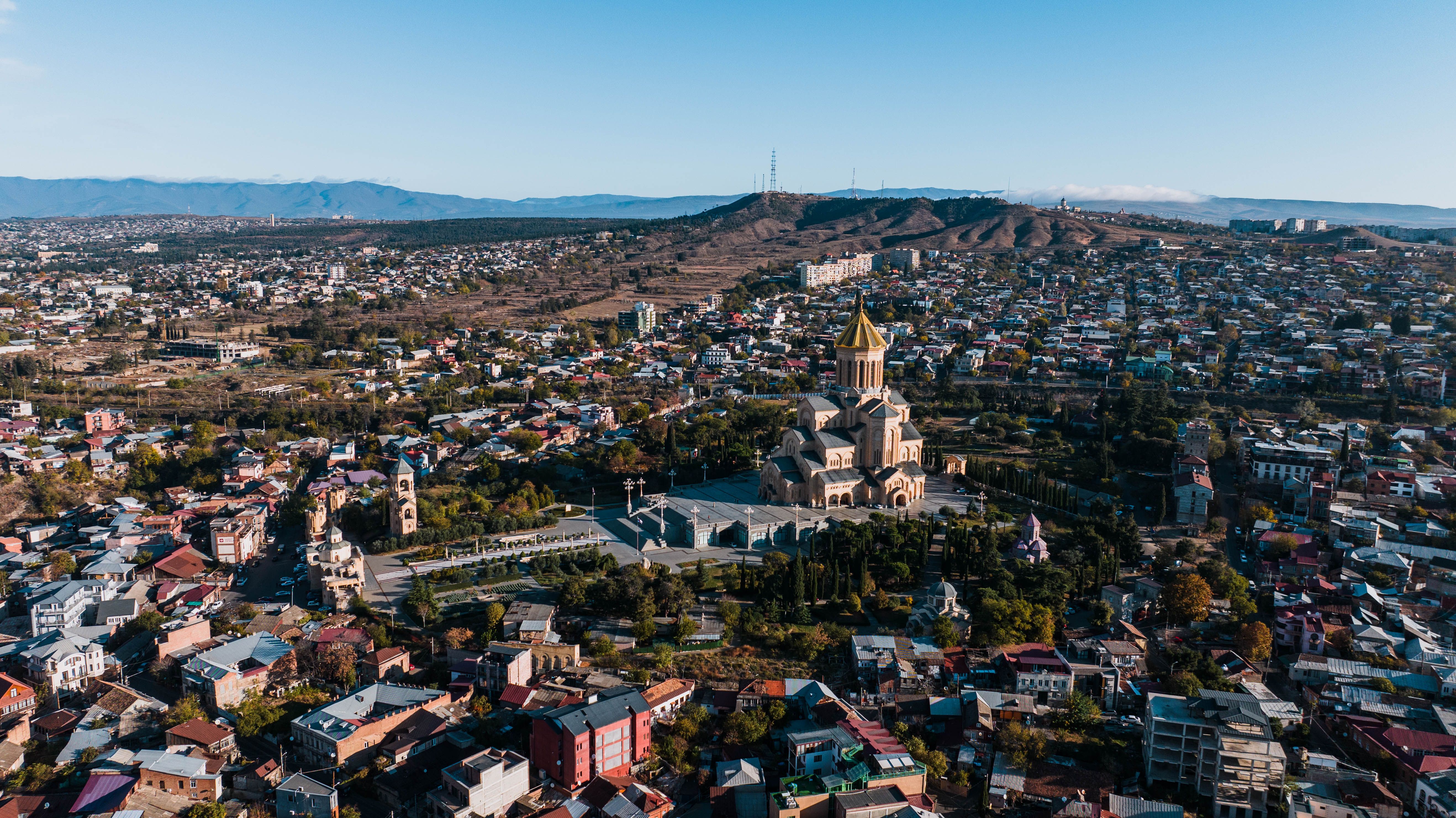 Breathtaking aerial view of Tbilisi showcasing the Holy Trinity Cathedral amidst a sprawling cityscape.