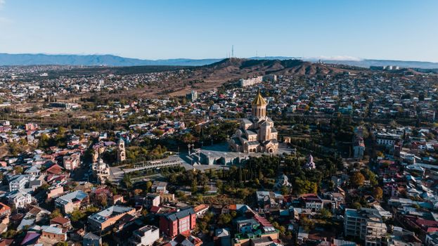 Breathtaking aerial view of Tbilisi showcasing the Holy Trinity Cathedral amidst a sprawling cityscape.