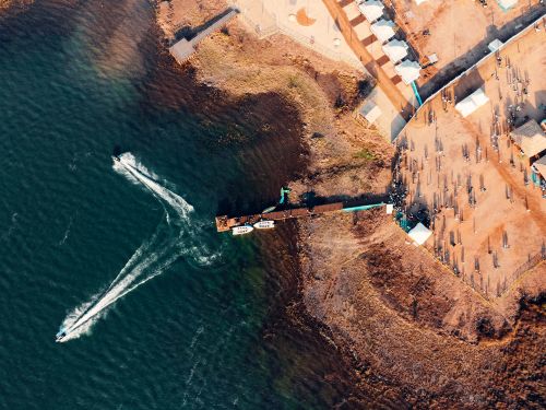 Free A stunning aerial view of Sambalpur harbor showcasing a pier and watercraft on a clear day. Stock Photo
