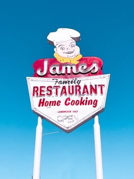 Iconic vintage sign of James Restaurant under a clear blue sky, San Fernando.