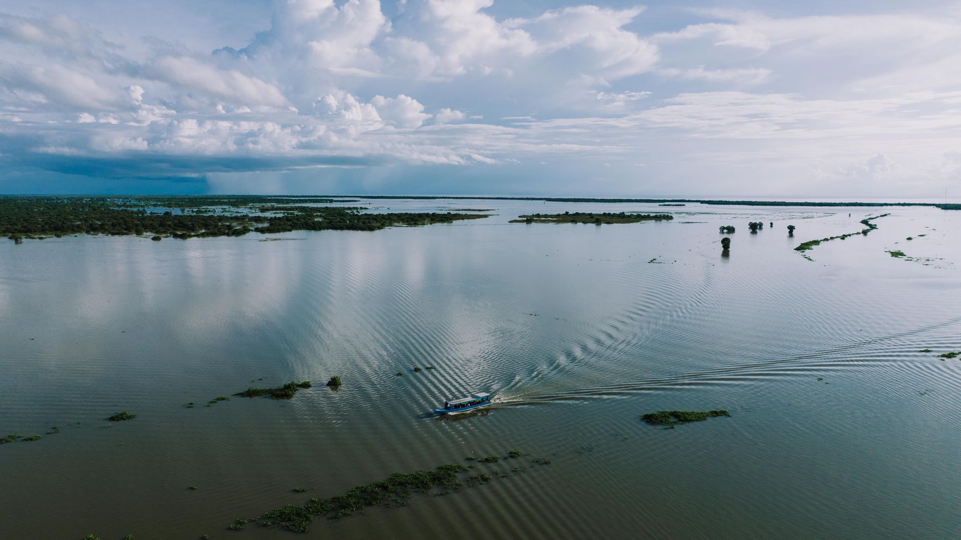 Aerial view of a serene lake in Kampong Khleang, Cambodia, showcasing natural beauty and tranquil scenery.